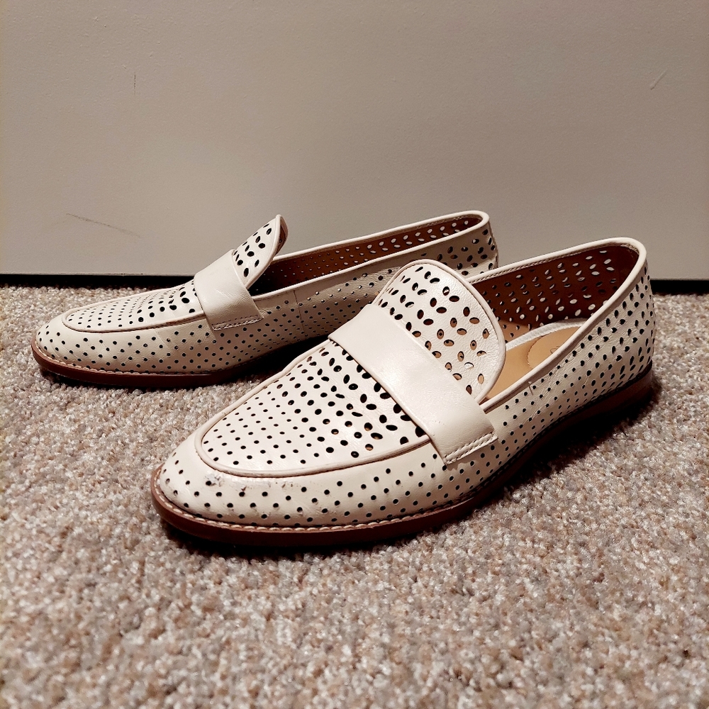 White leather loafers with cut out designs